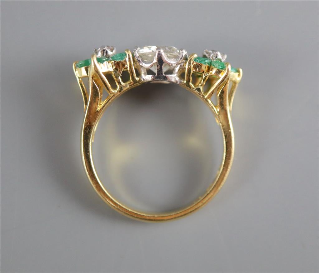 A modern 18k emerald and diamond set dress ring,